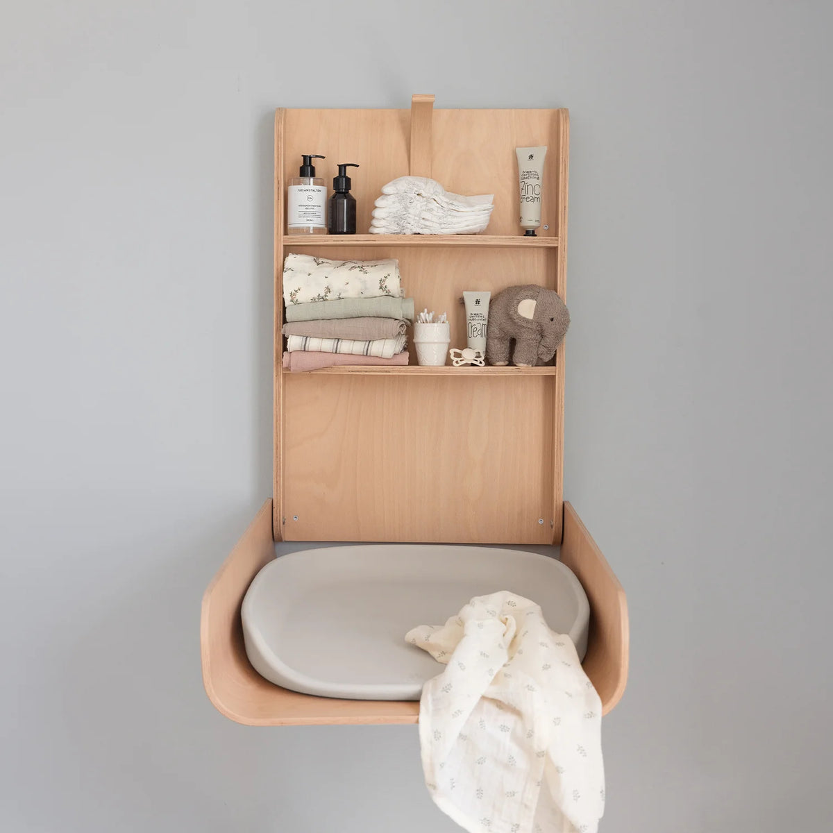 Close view of sebra wall mounted chaning table with chaning mat on the wall.