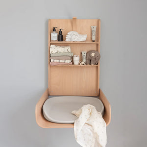 Close view of sebra wall mounted chaning table with chaning mat on the wall.