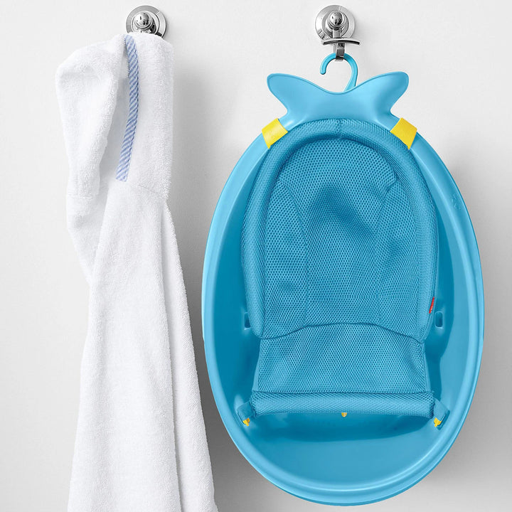 Blue Skip Hop Moby 3-Stage Baby Bathtub with mesh sling in higher newborn position.