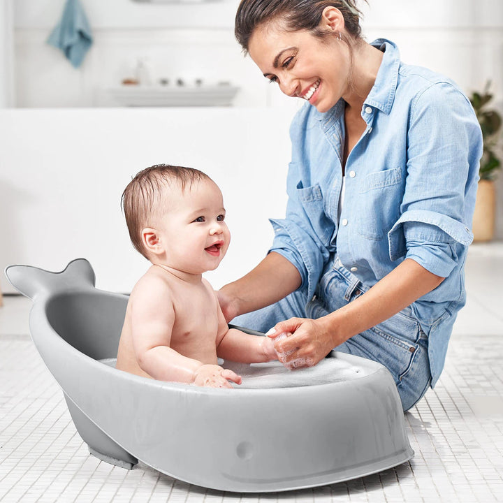 Grey Skip Hop Moby 3-Stage Bathtub with an older baby bathing without the sling.