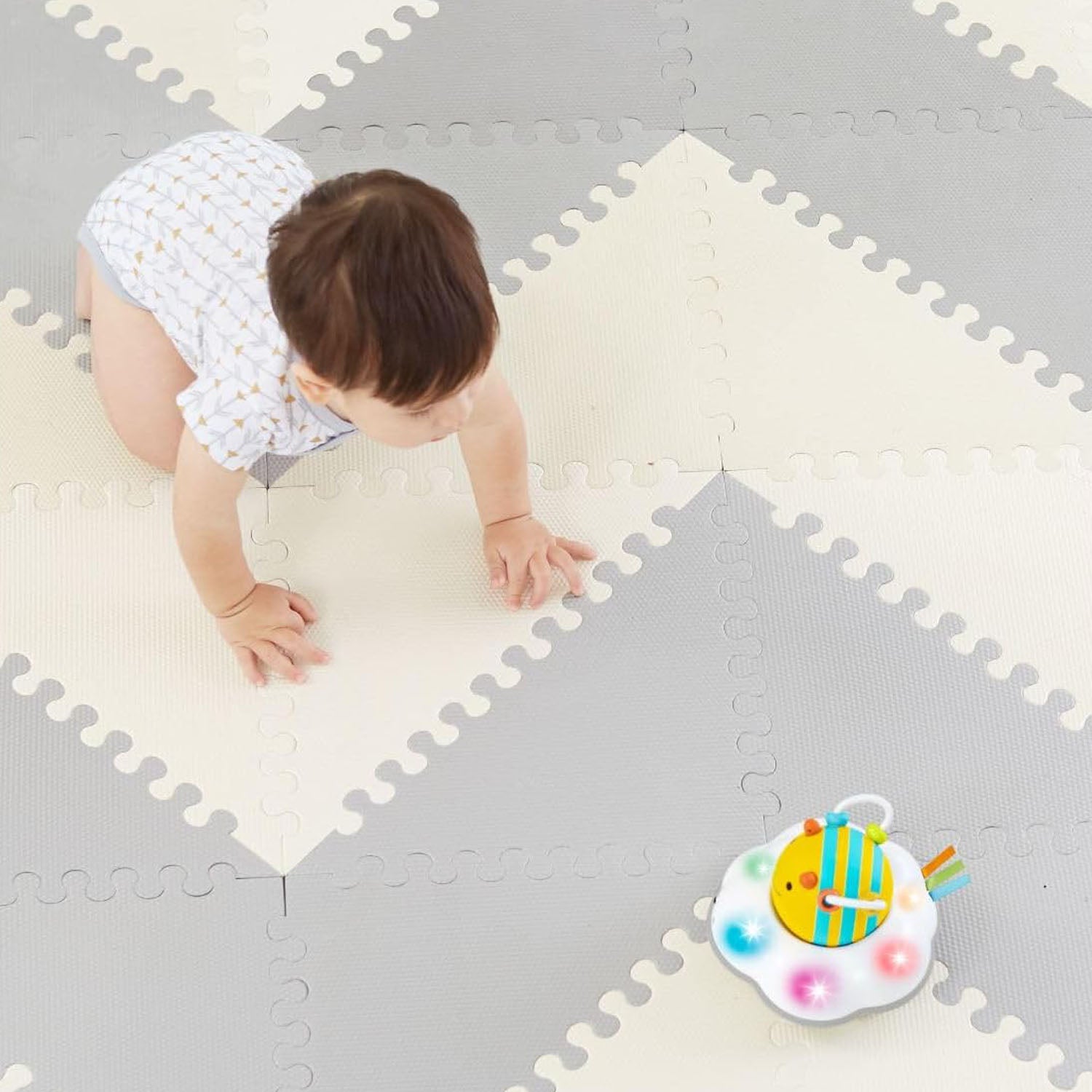 Baby playing safely and comfortably on a decor-friendly soft foam play mat.