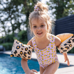 A girl is having fun in the pool wearing the swim essentials armband