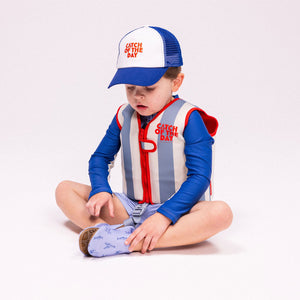 A young child wearing the "Catch of the Day" swim vest.