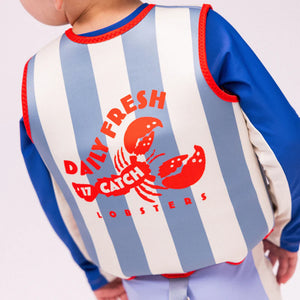 A child is wearing the swim essentials vest.