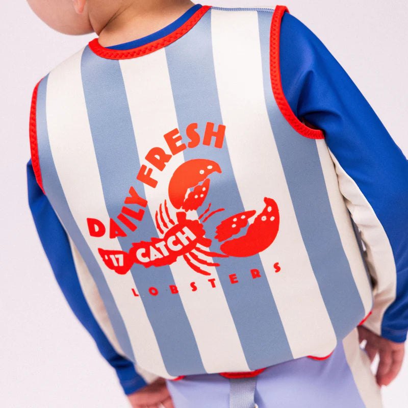 A child is wearing the swim essentials vest.