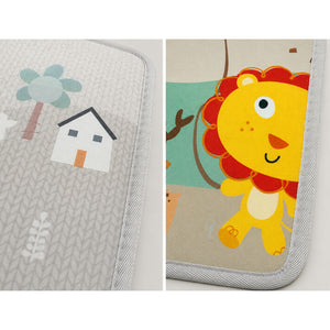 Two close-up views of a children's play mat or cushion with stitched edges. The left view shows a light gray patterned section with a house and tree motif.