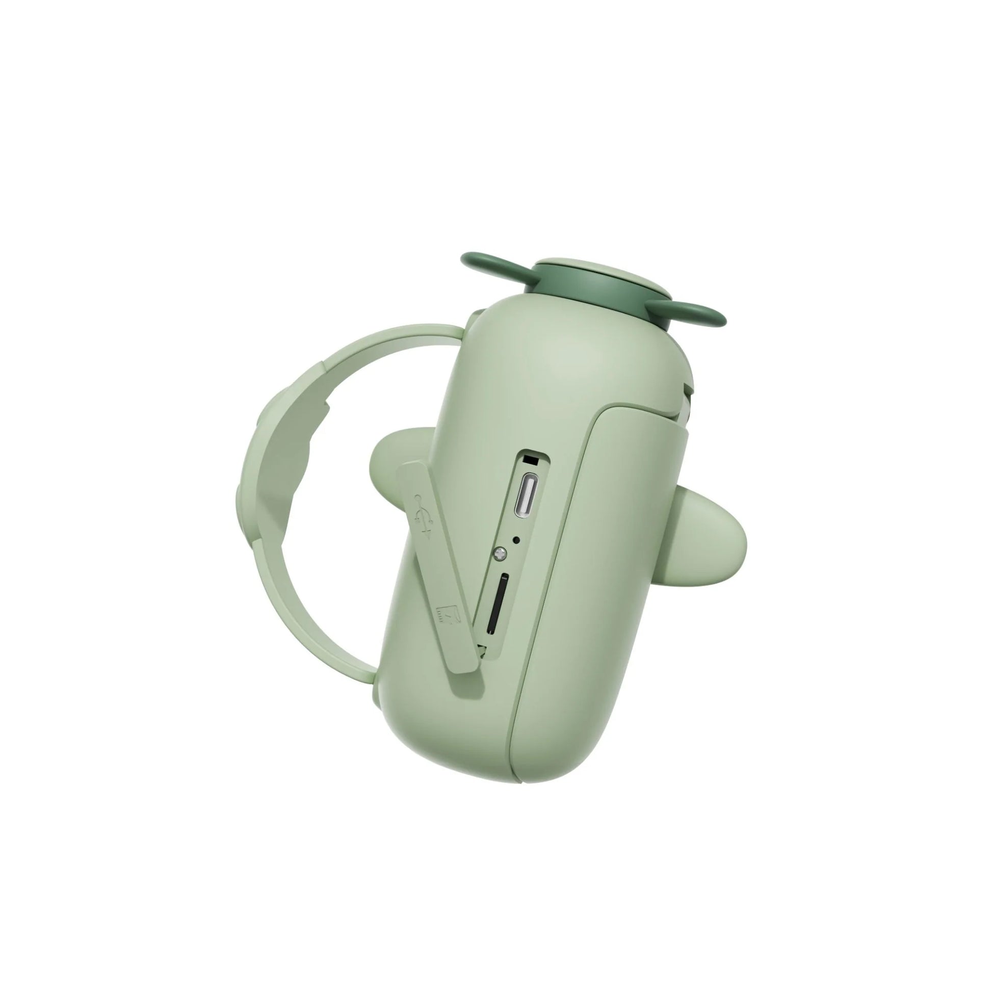 Close-up of dino zoo video camera with wrist strap, charging connector and memory card slot.