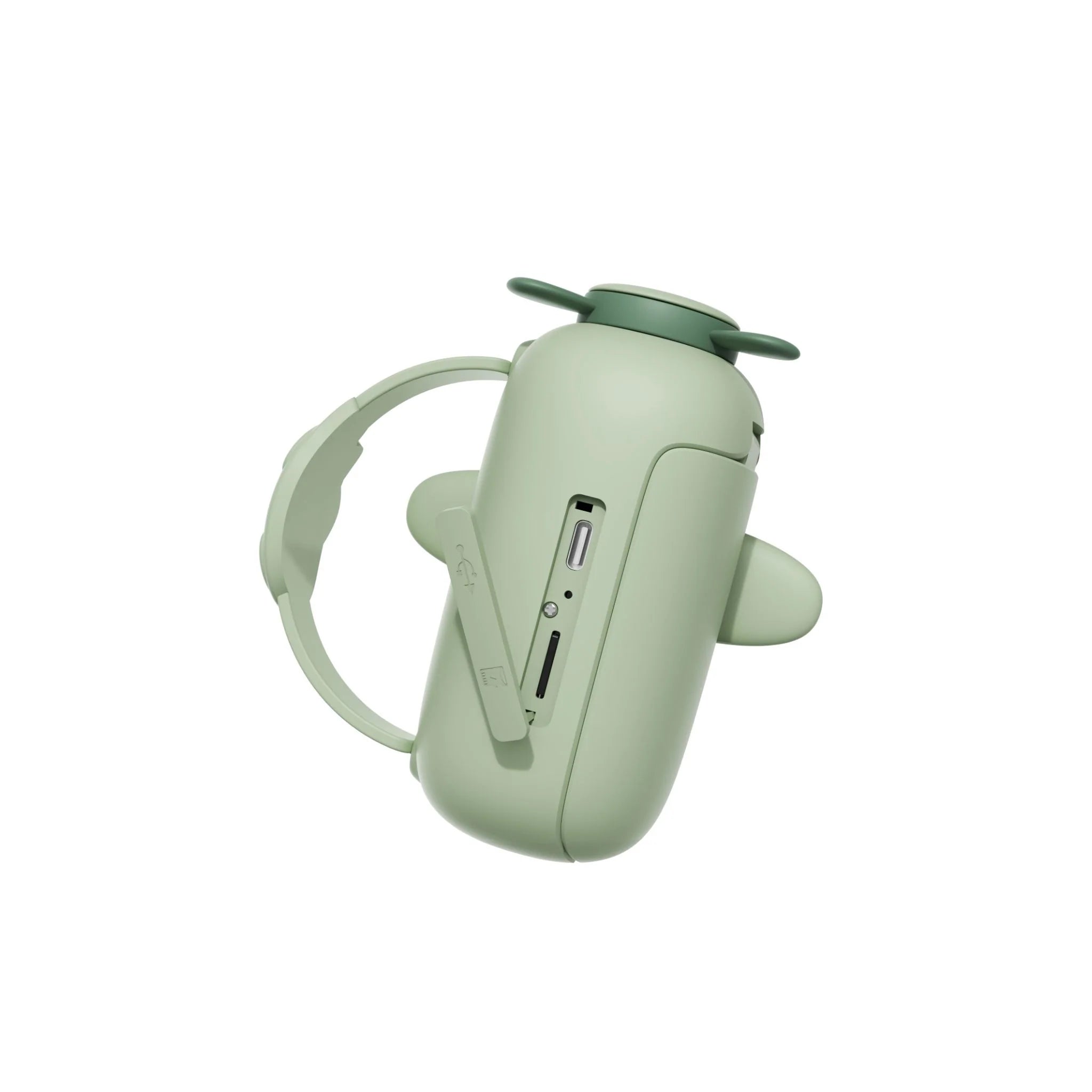 Close-up of dino zoo video camera with wrist strap, charging connector and memory card slot.