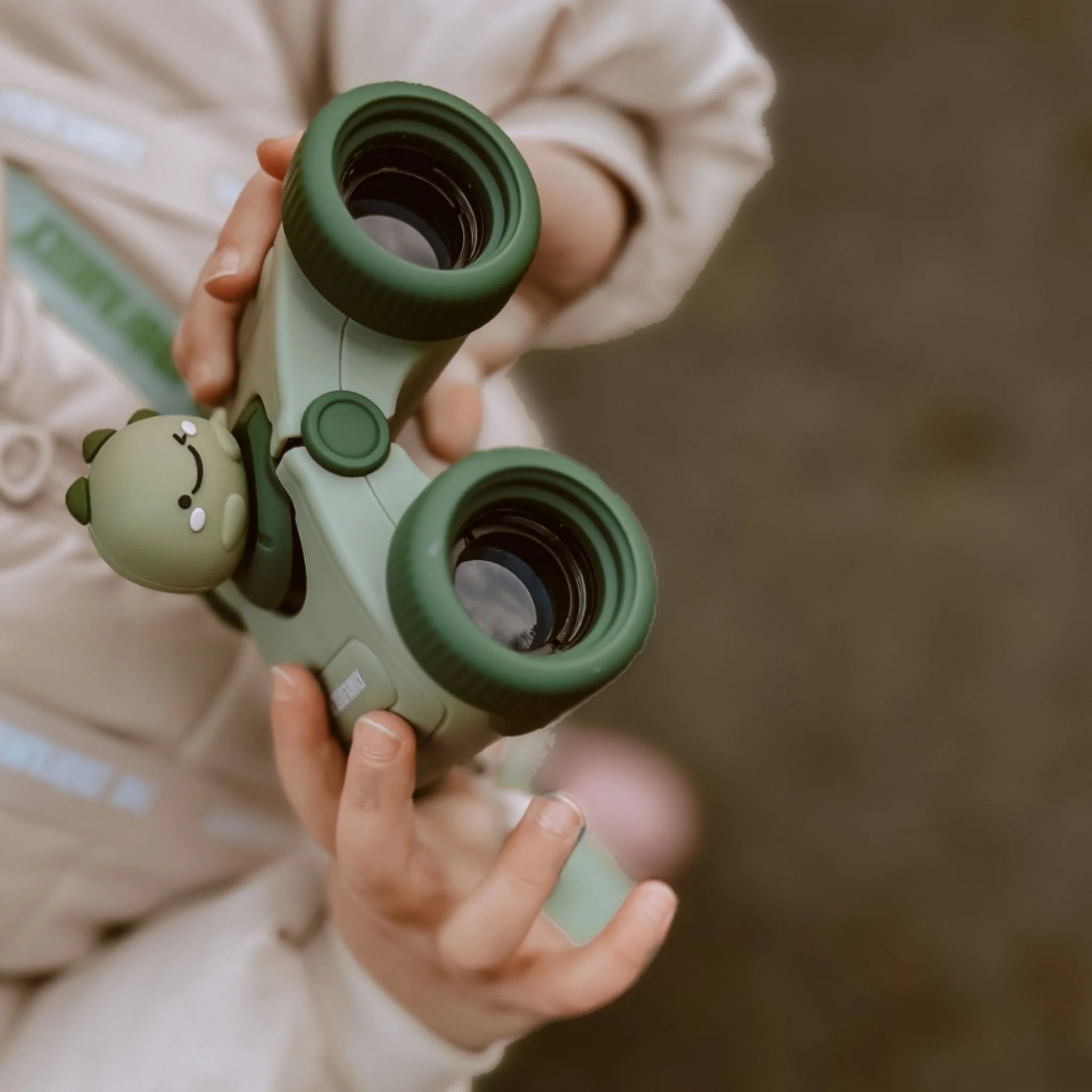 Girl learning outdoors with zoo eyes adventure binoculars.