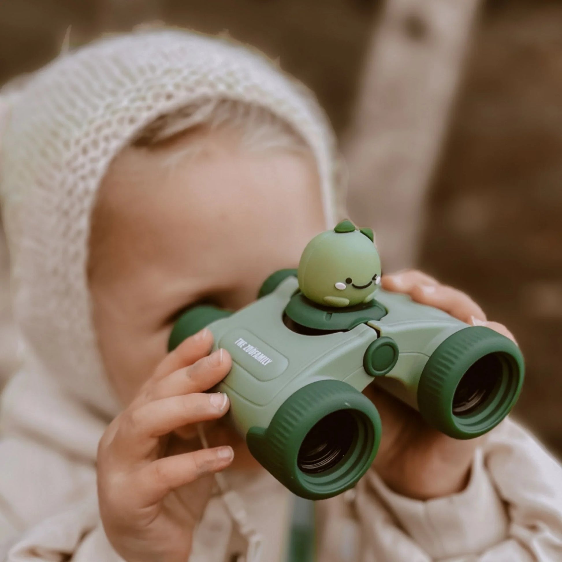 Girl looking through Zoo Eyes kids binoculars.