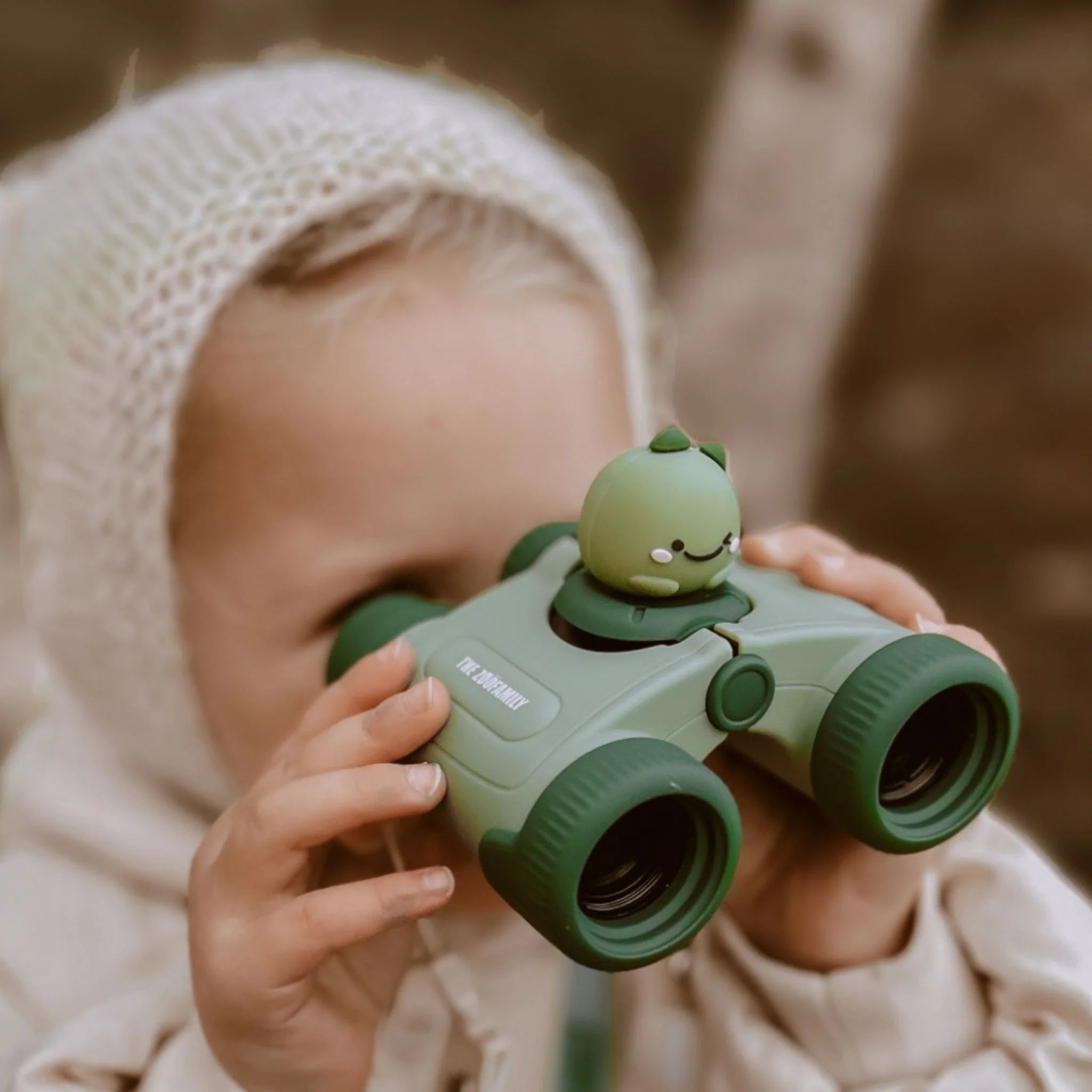 Girl looking through Zoo Eyes kids binoculars.