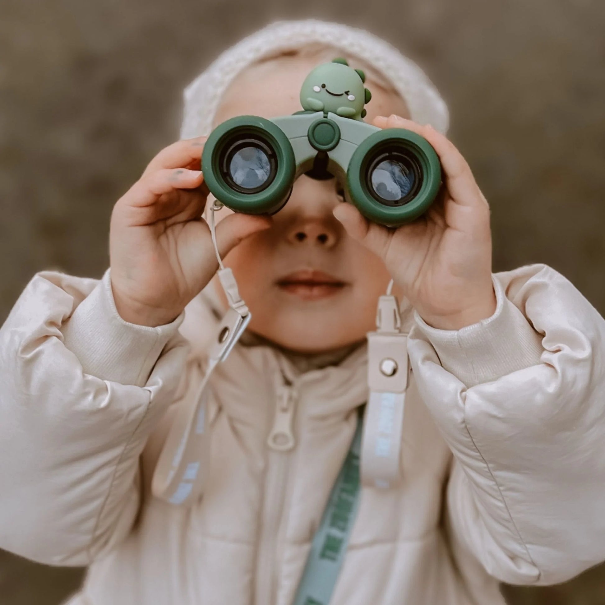 Girl on an adventure with zoo eyes binoculars.