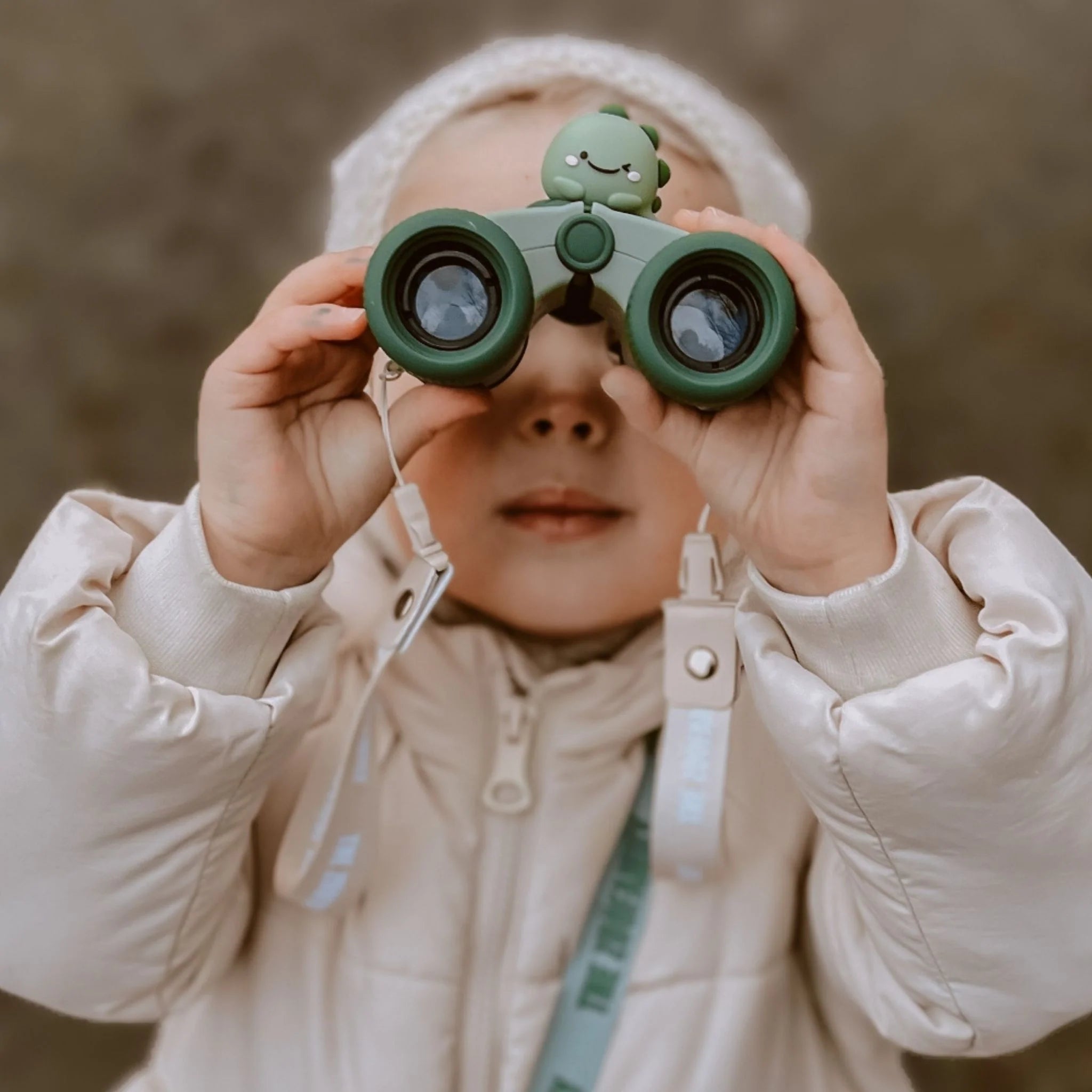 Girl on an adventure with zoo eyes binoculars.