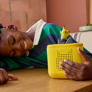 A boy is happily listening to the Pokemon pikachu tonie in the toniebox 2