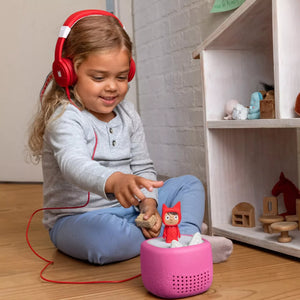 Young child using pink Toniebox Lite with silicone cover at home, fun storytime for little ones