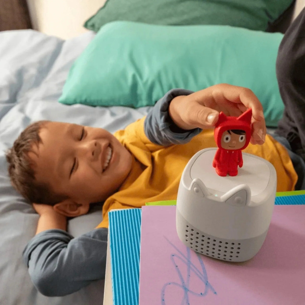 Child using Toniebox Lite at bedtime, showing sleep timer feature for calm winding down