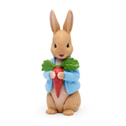 Tonies Figure of a rabbit holding a carrot with a green leaf on a white background