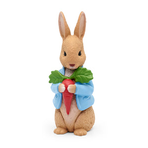 Tonies Figure of a rabbit holding a carrot with a green leaf on a white background