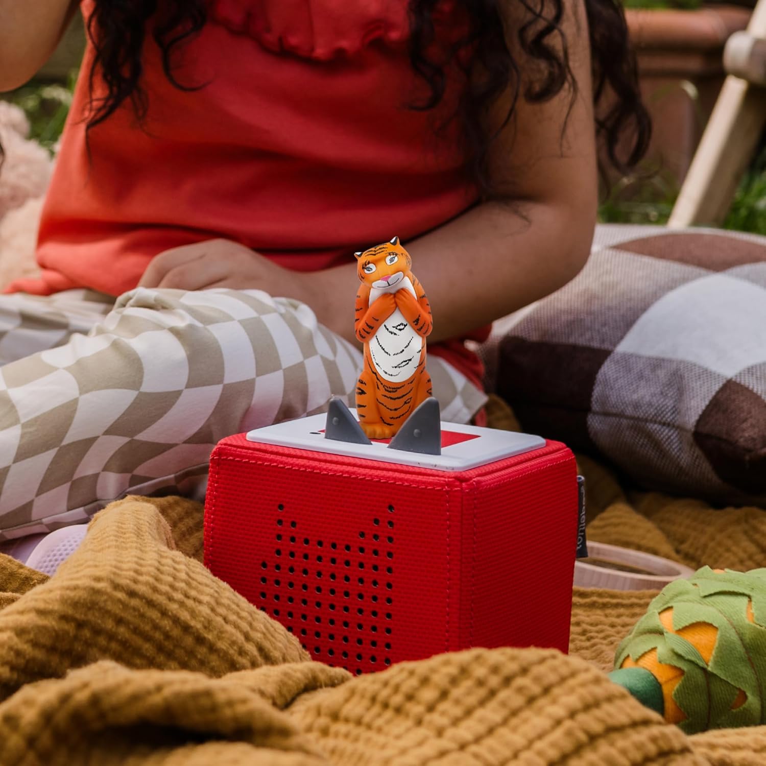 The Tiger Tonie figure placed magnetically on top of a Toniebox ready to play.
