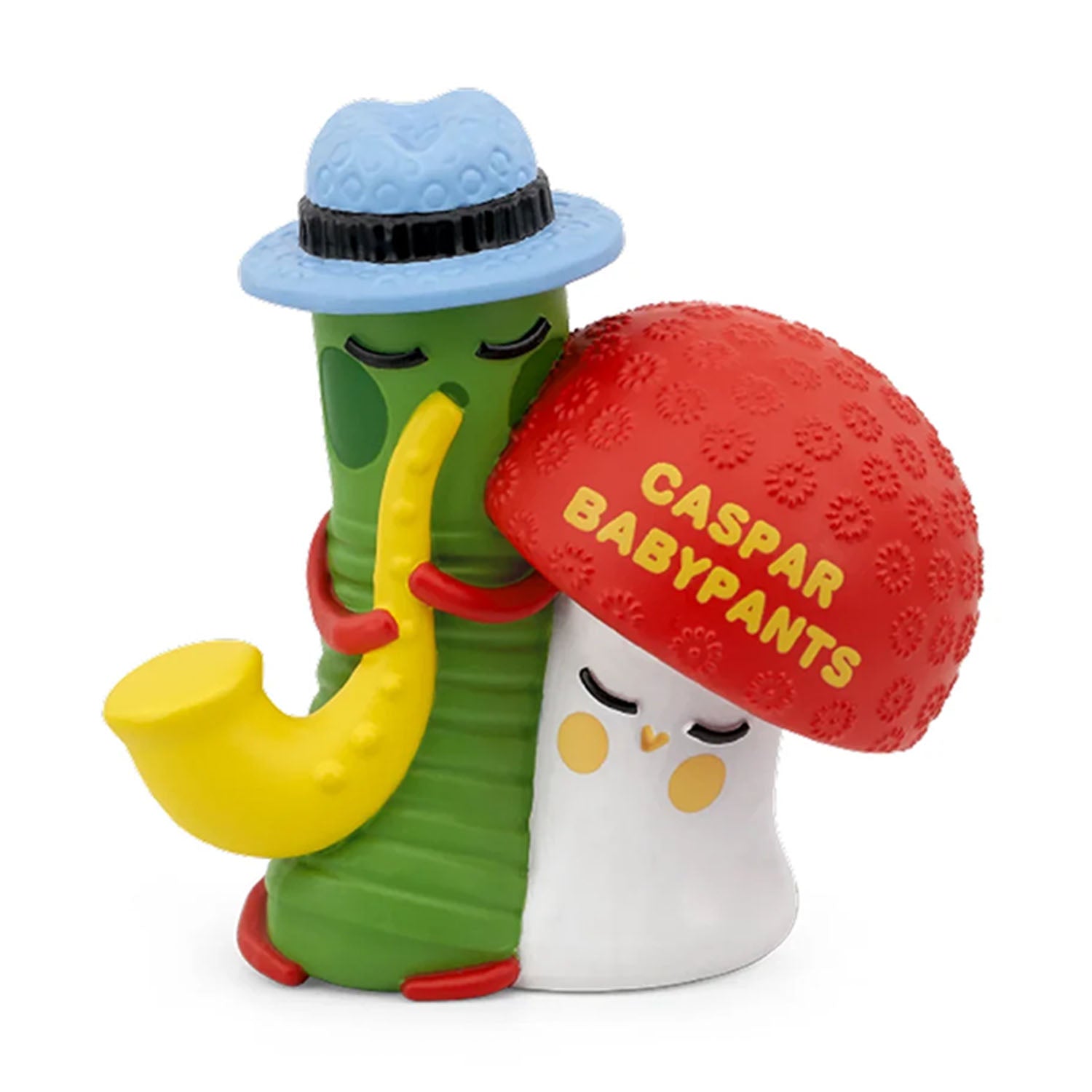 Close up of the Tonies Caspar Babypants audio figure, featuring a green character wearing a blue hat and playing a yellow saxophone next to a red mushroom.