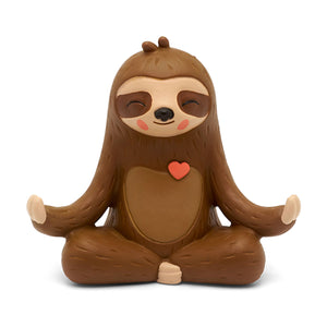Close-up of the brown Mo the Sloth Tonie figure sitting cross-legged in a meditative pose with a small red heart on its chest.