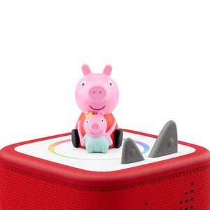 A Tonie figurine of Peppa Pig standing on a red Toniebox, perfect for children's audio storytelling and family adventures.