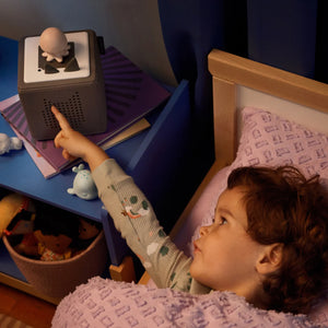 Child placing Sleepy Octopus Tonie on Toniebox