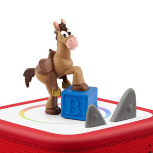 Tonies Toy Story 5 Bullseye audio figure placed magnetically on the red top surface of a Toniebox speaker to demonstrate how to start playing the audio story.