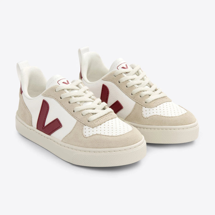 White Veja V-10 sneakers with marsala accents, ChromeFree leather upper, and a sustainable outsole.