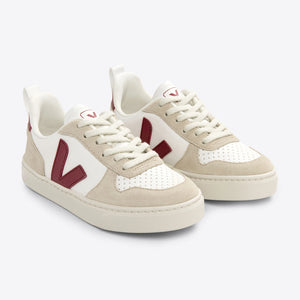 White Veja V-10 sneakers with marsala accents, ChromeFree leather upper, and a sustainable outsole.