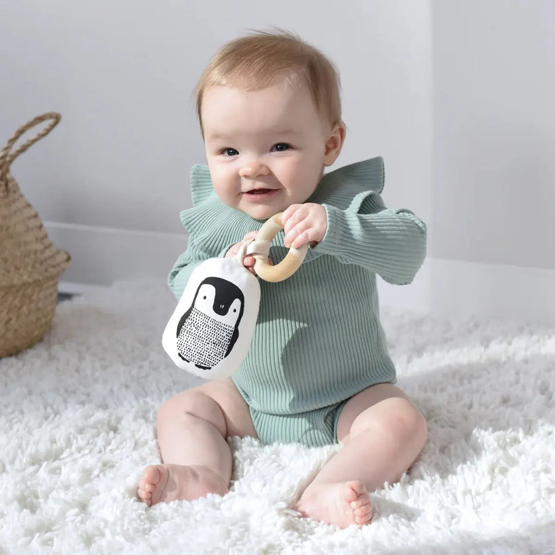 Baby playing with Little Naturalist gift set teether.
