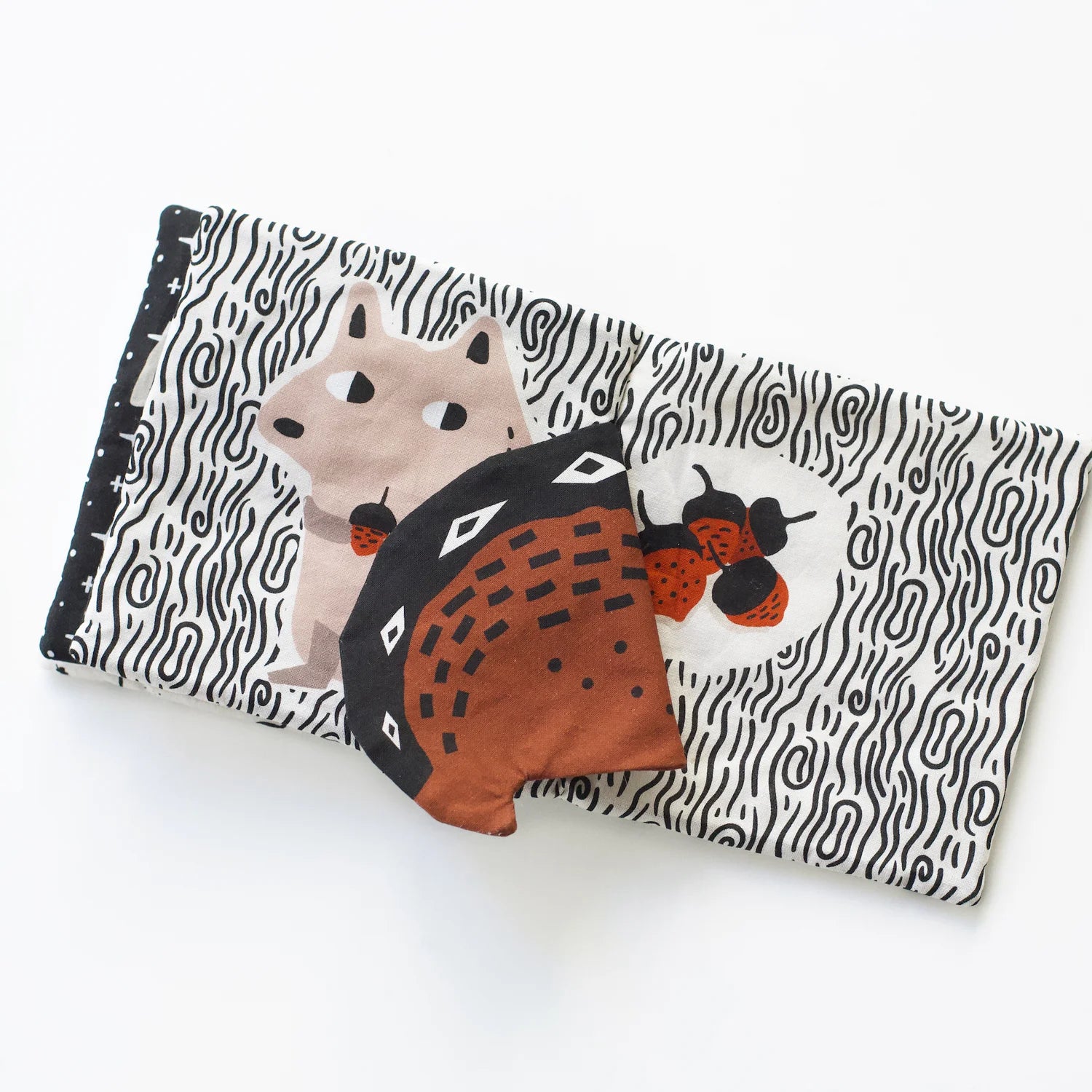 Fabric baby book with crinkly flaps for auditory and tactile stimulation.