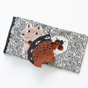 Fabric baby book with crinkly flaps for auditory and tactile stimulation.