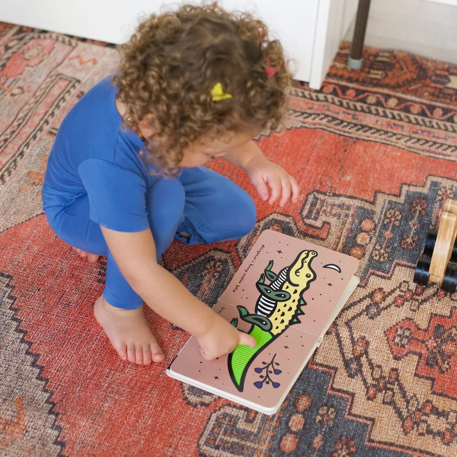 Baby-friendly board page from Wee Gallery Tails with colorful animal illustrations