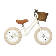 White banwood balance bike vintage first go witht basket in a white background.