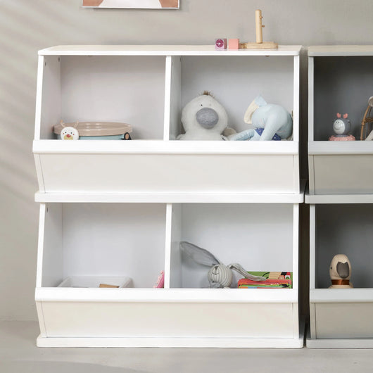 Two white wooden toy storage trunks stacked for space-saving organization.