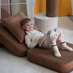 A toddler is relaxing on the flip foldable chair.