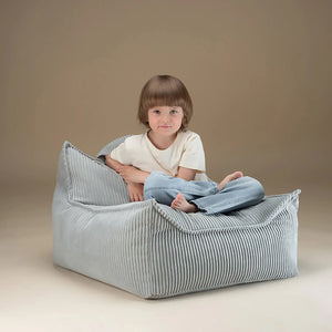 A boy is sitting on Wigiwama bean bag.