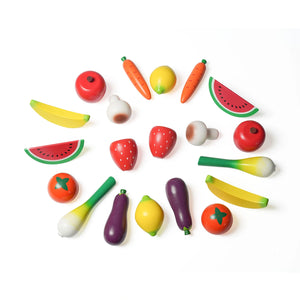 White background with colourful wooden toy fruits and vegetables. Contains apples, bananas, watermelon, strawberries, carrots, eggplants, lemons, tomatoes, mushrooms, and leeks. Children can pretend with the realistically shaped and painted toys.