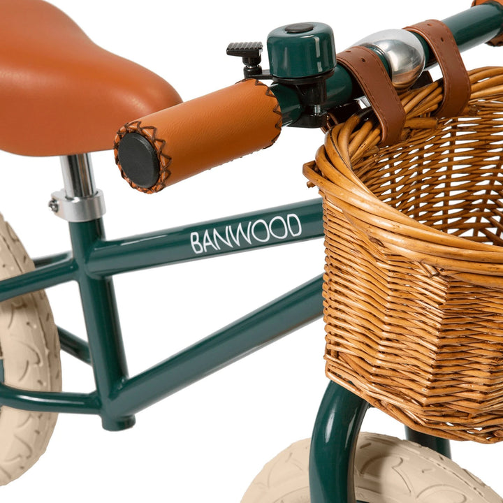Close-up of the bike's wicker basket and faux-leather seat