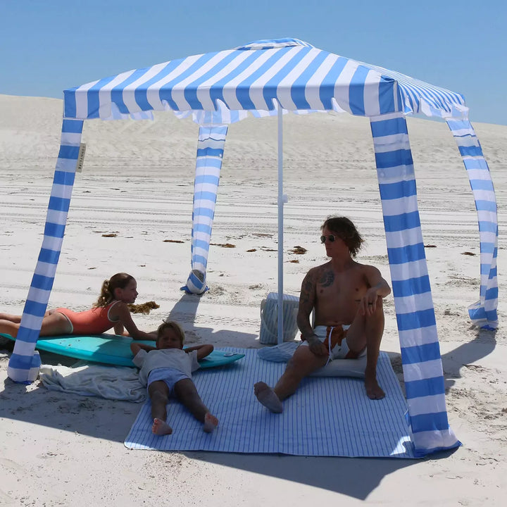 A happy family lounging comfortably under the Le Weekend Beach Cabana, shielded from the sun's rays by its UPF 50+ protection