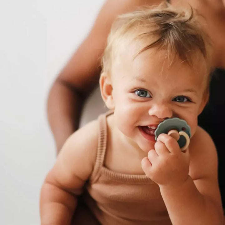 Baby with dummy in mouth