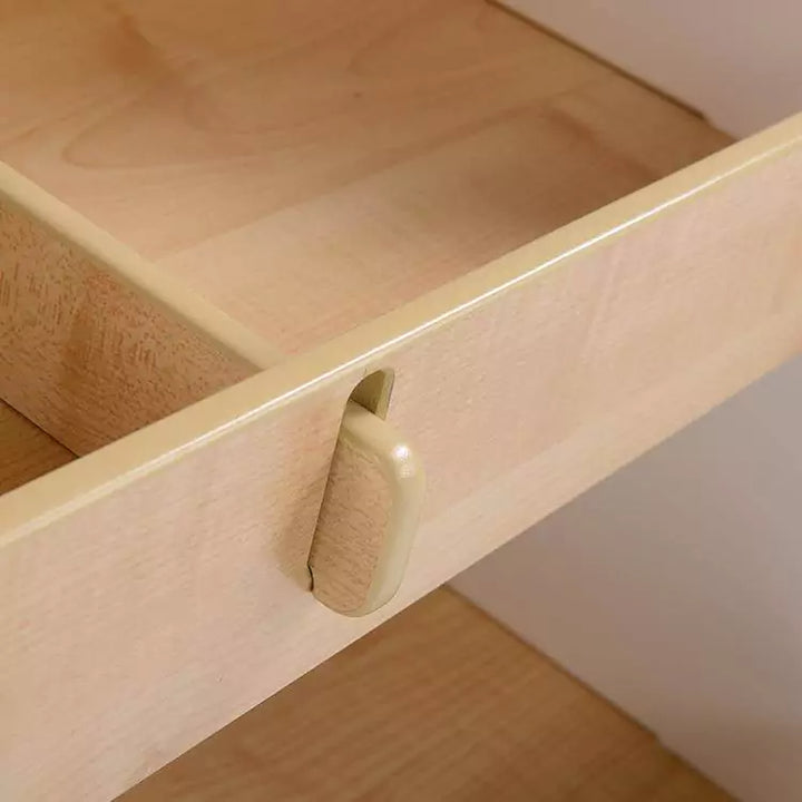  A close up of a wooden drawer with a handle on it. The drawer appears to be made of solid wood and has a smooth, polished surface.