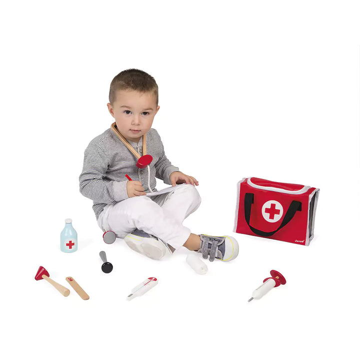 A boy is playing with Doctor's suitcase