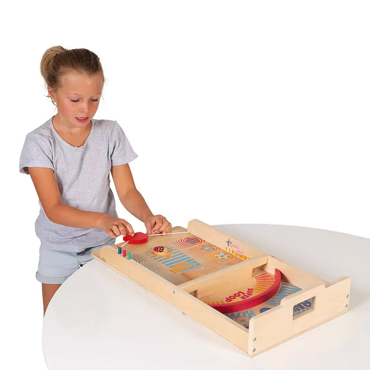 Child playing with wooden paddle game