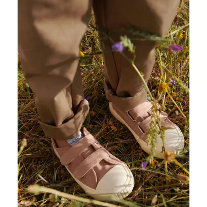 Child wearing Liewood Canvas Shoes  Pale Tuscany in the park 