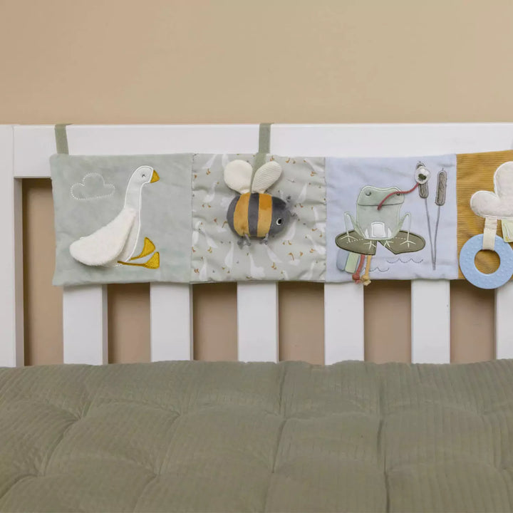This playpen activity book is made of soft and textured fabrics that encourage tactile exploration for infants.