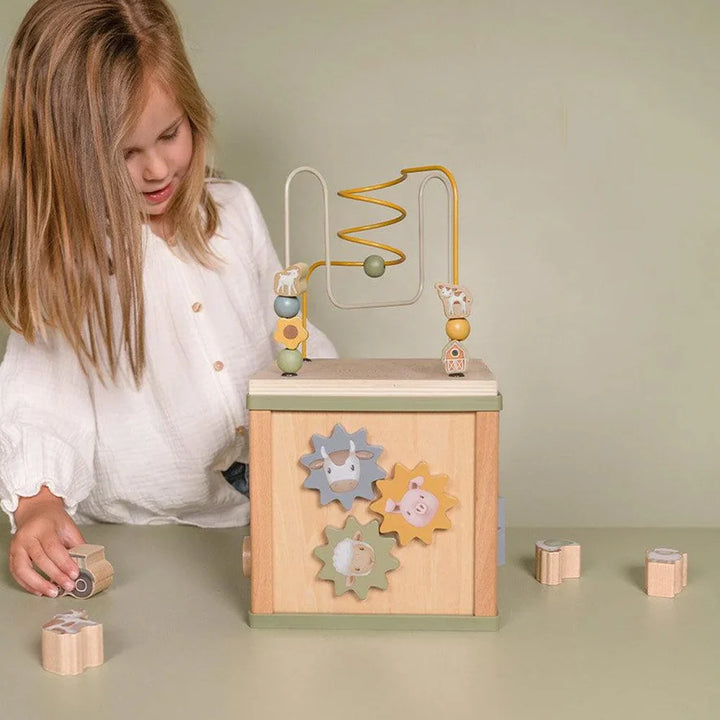 A maze atop the wooden cube beckons curious hands to navigate, refining fine motor skills.