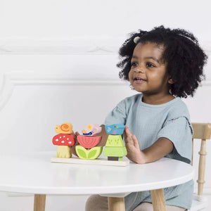 Child playing with wooden stacking toys