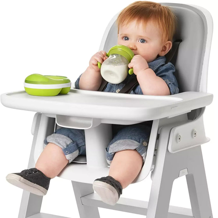 A baby drinking milk by hand with Tot Transitions Spout Sippy Cup